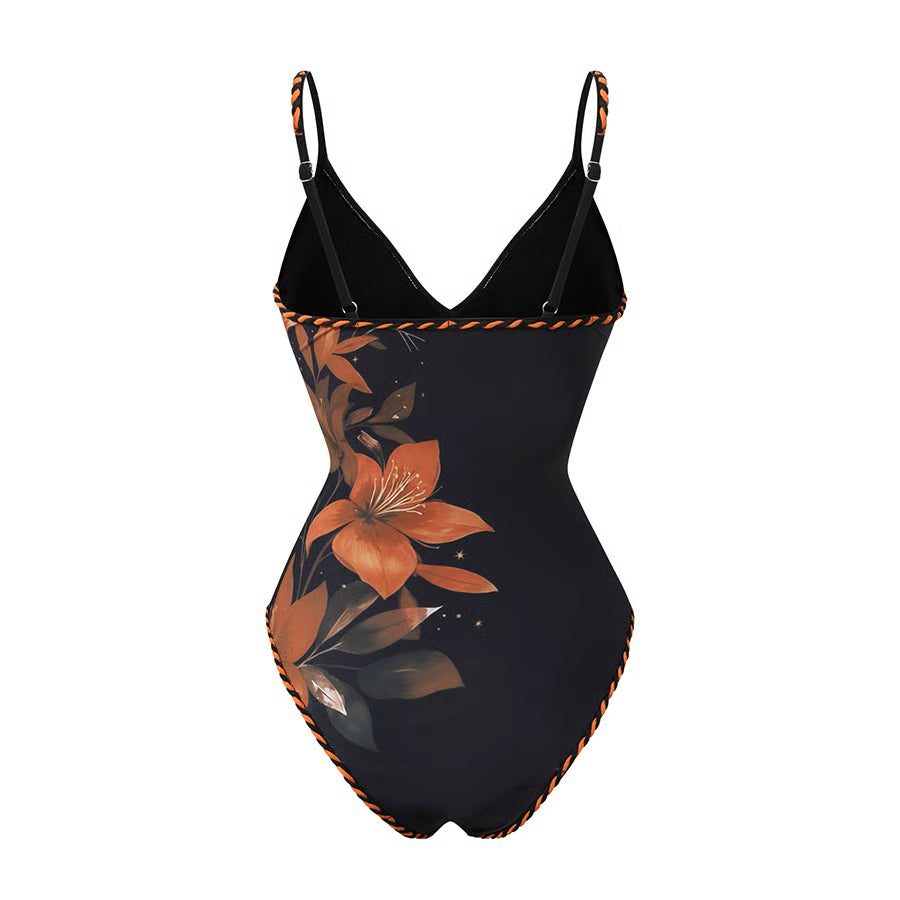 Bañador Orlena negro y naranja con estampado floral y pareo de flecos